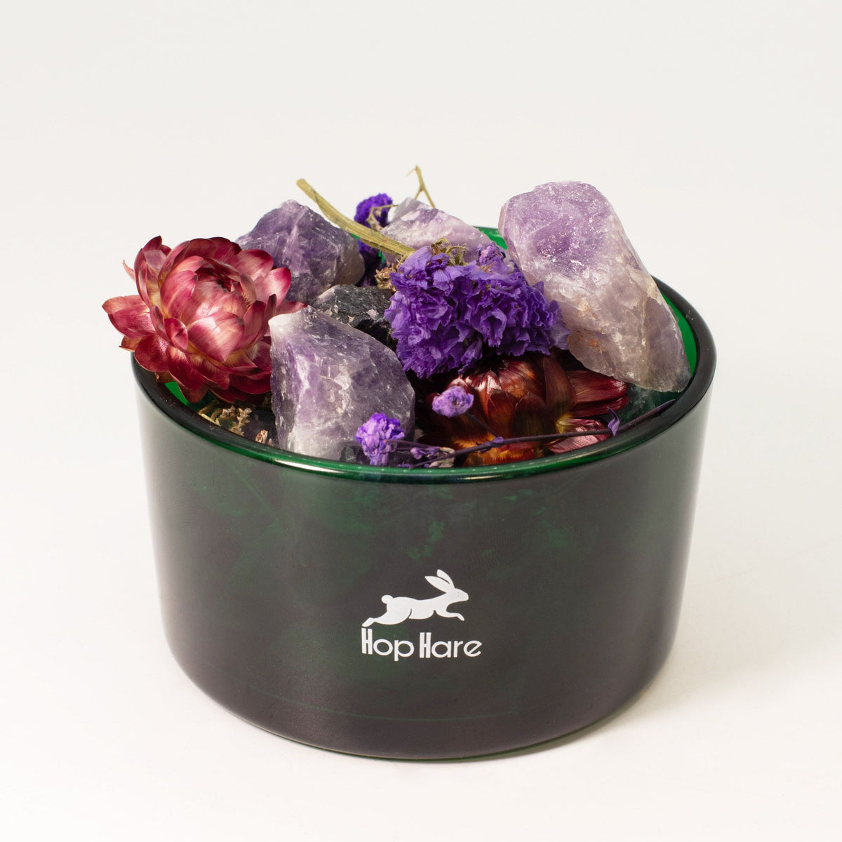 Black container with crystals and flowers on a white background, featuring the Hopplare logo.