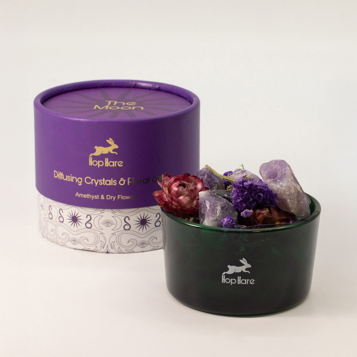Diffusing crystals and floral mix in a black container with a purple lid, featuring the 'lop itare' brand.