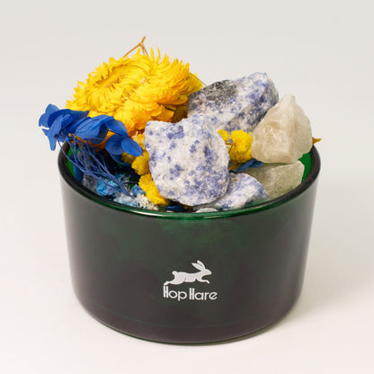 Black container with rocks and flowers on a white background, featuring the 'lopHare' brand.