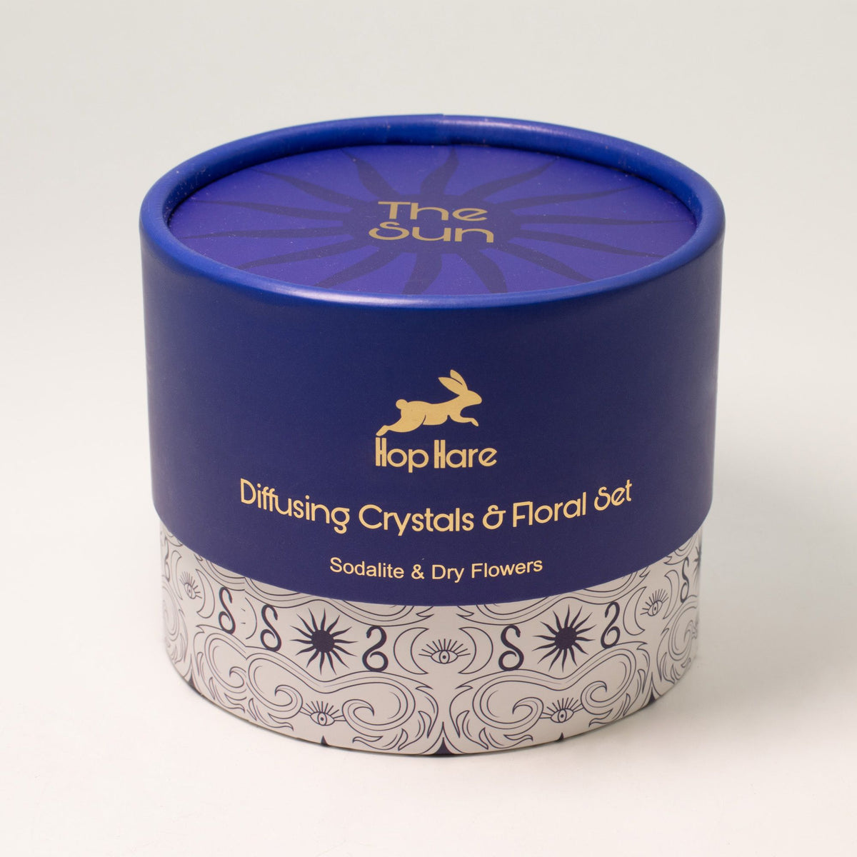Blue cylindrical container with floral design on a white background