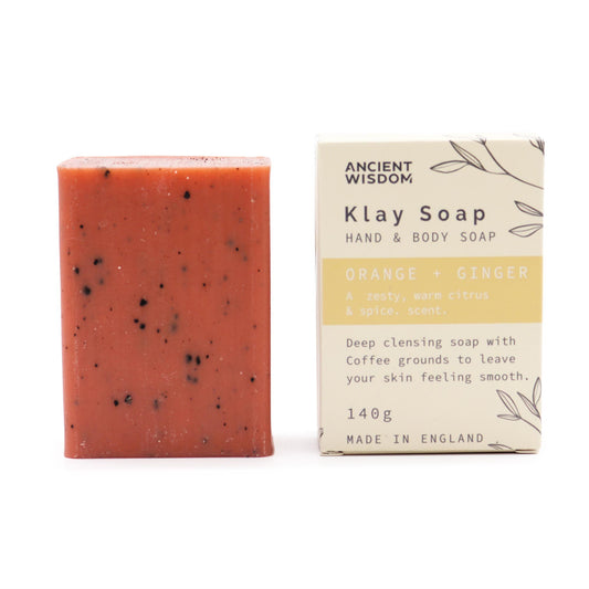 Red bar of soap next to its packaging on a white background