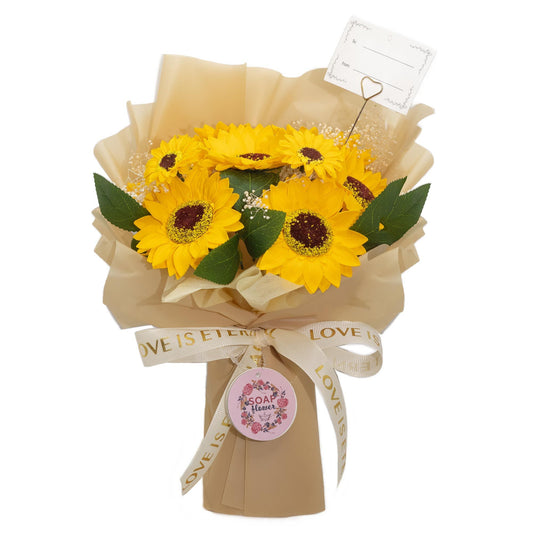 Bouquet of yellow sunflowers wrapped in beige paper with a decorative tag on a white background