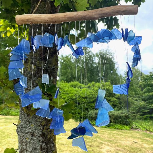 Bring harmony and a touch of nature to your outdoor space with a Recycled Glass Wind Chime Love Chime Blue. 