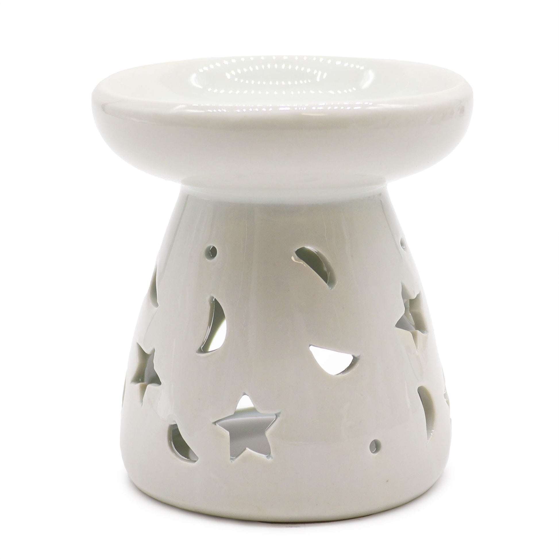 White ceramic oil burner with star and moon cutouts on a white background