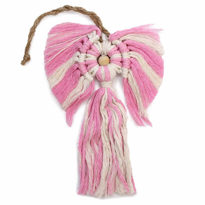 Pink and white macrame wall hanging with a wooden center on a white background