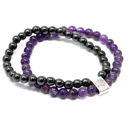 Two beaded bracelets, one black and one purple, on a white background.