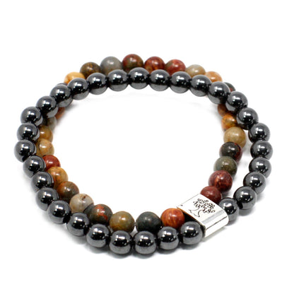 Beaded bracelet with gray and multicolored beads on a white background