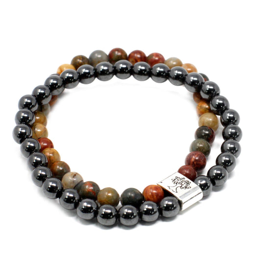 Beaded bracelet with gray and multicolored beads on a white background