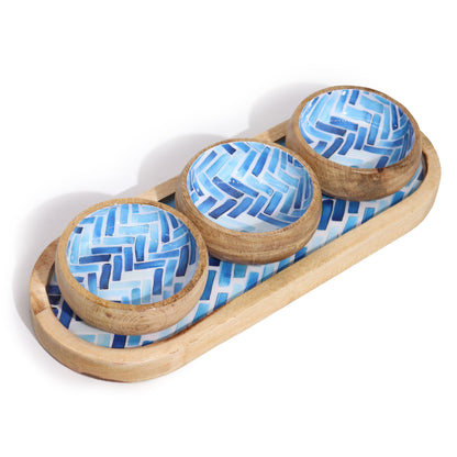 Three wooden bowls with blue geometric patterns on a matching wooden tray.