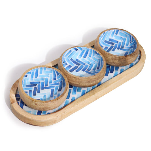 Three wooden bowls with blue geometric patterns on a matching wooden tray.