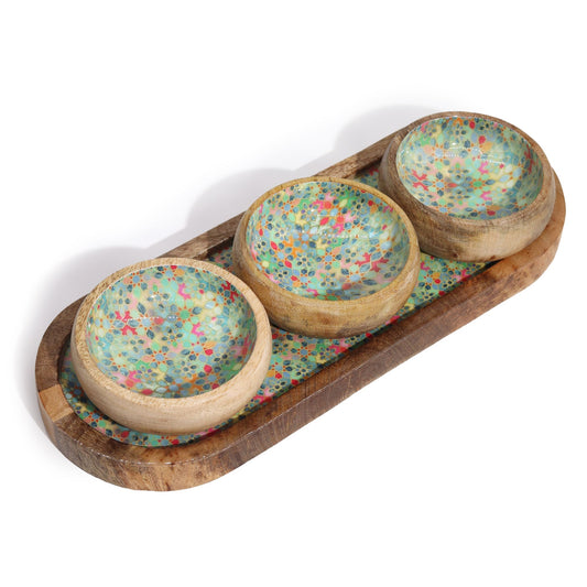 Three wooden bowls with colorful speckled design on a wooden tray