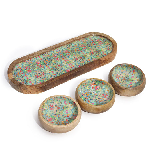Set of wooden trays with multicolored speckled design on a white background