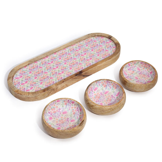 Set of wooden bowls with floral pattern on a white background