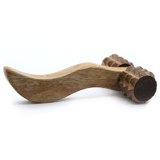 Wooden tool with a curved handle and round head on a white background