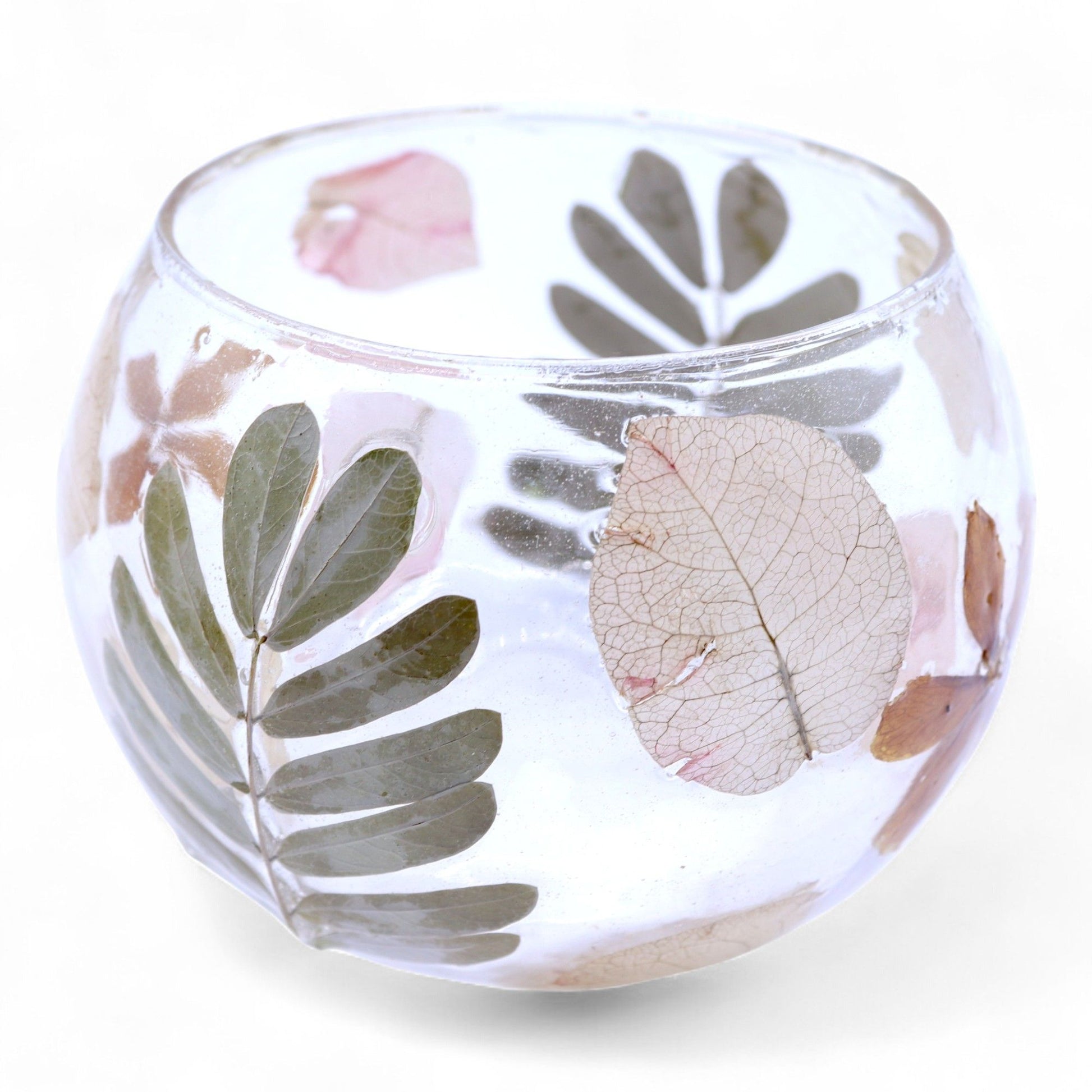 Glass bowl with floral and leaf designs on a white background