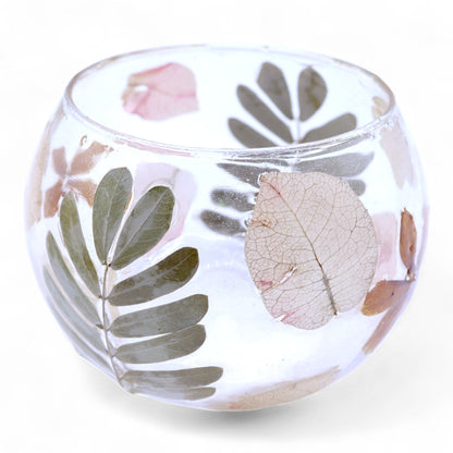 Glass bowl with floral and leaf designs on a white background