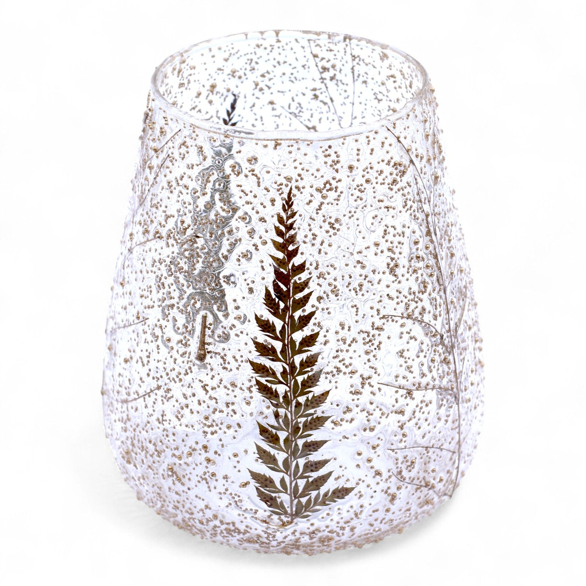 Speckled glass vase with a fern design on a white background