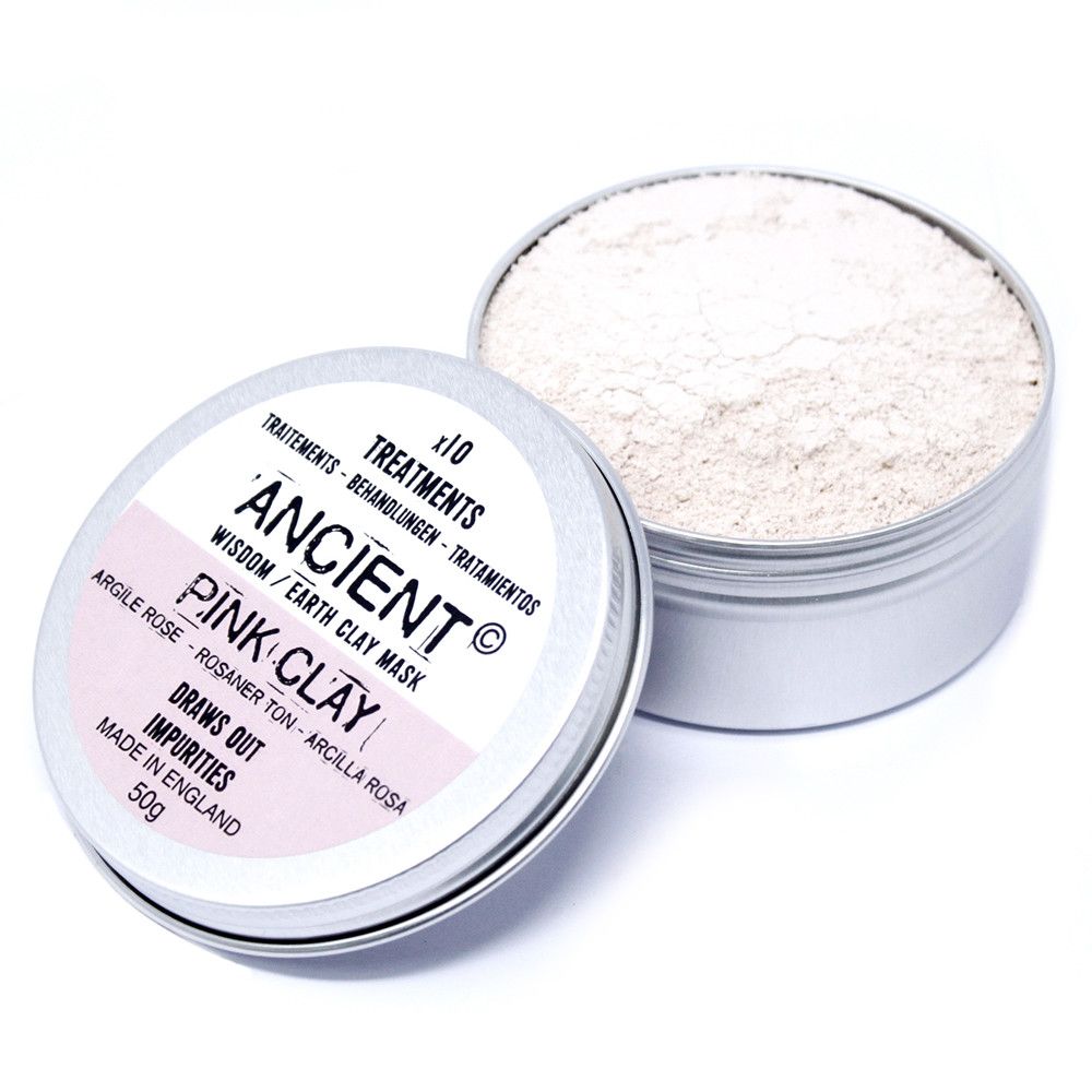 Open container of pink clay mask with visible powder inside on a white background