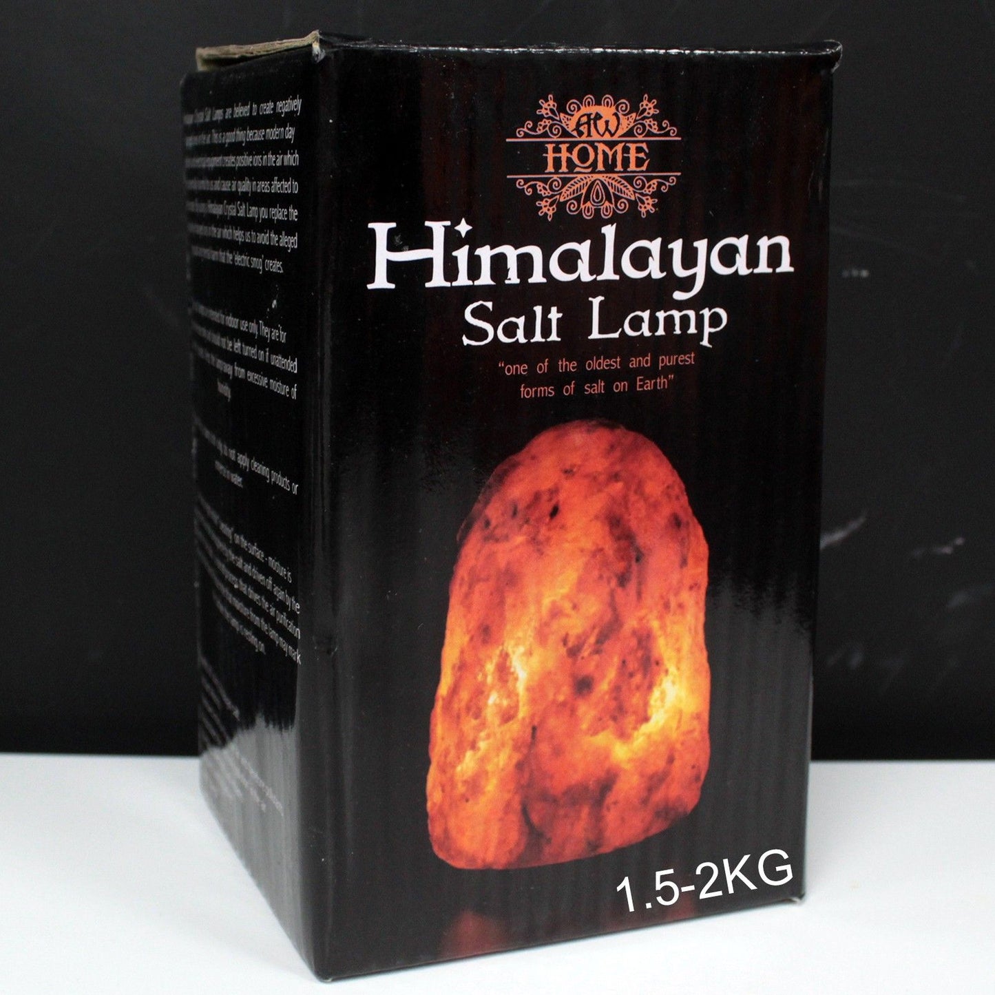 Box of Himalayan salt lamp with a glowing salt crystal on a black background
