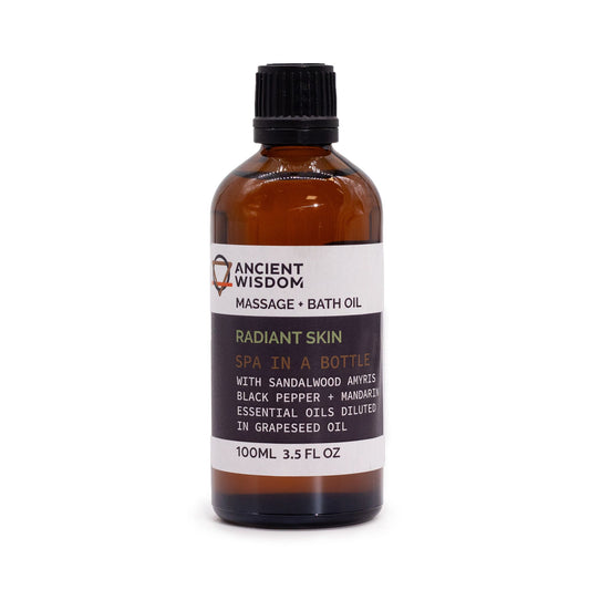 Bottle of Ancient Wisdom massage and bath oil on a white background