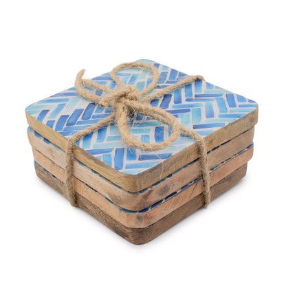 Set of square coasters with blue pattern and natural wood edges, tied together with twine on a white background.