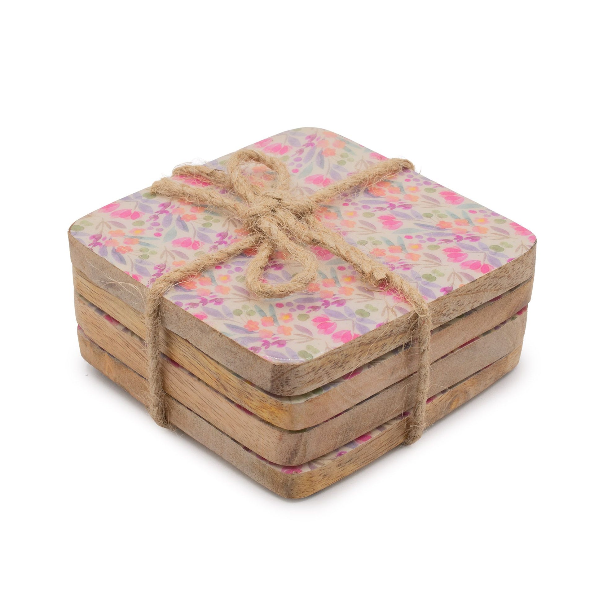 Set of square coasters with floral pattern tied with twine on a white background
