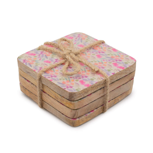 Set of square coasters with floral pattern tied with twine on a white background