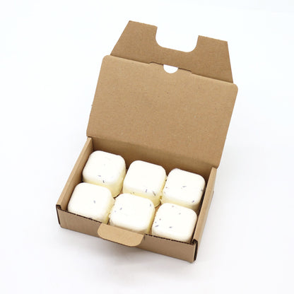 Box of six white shower steamers with green flecks on a white background