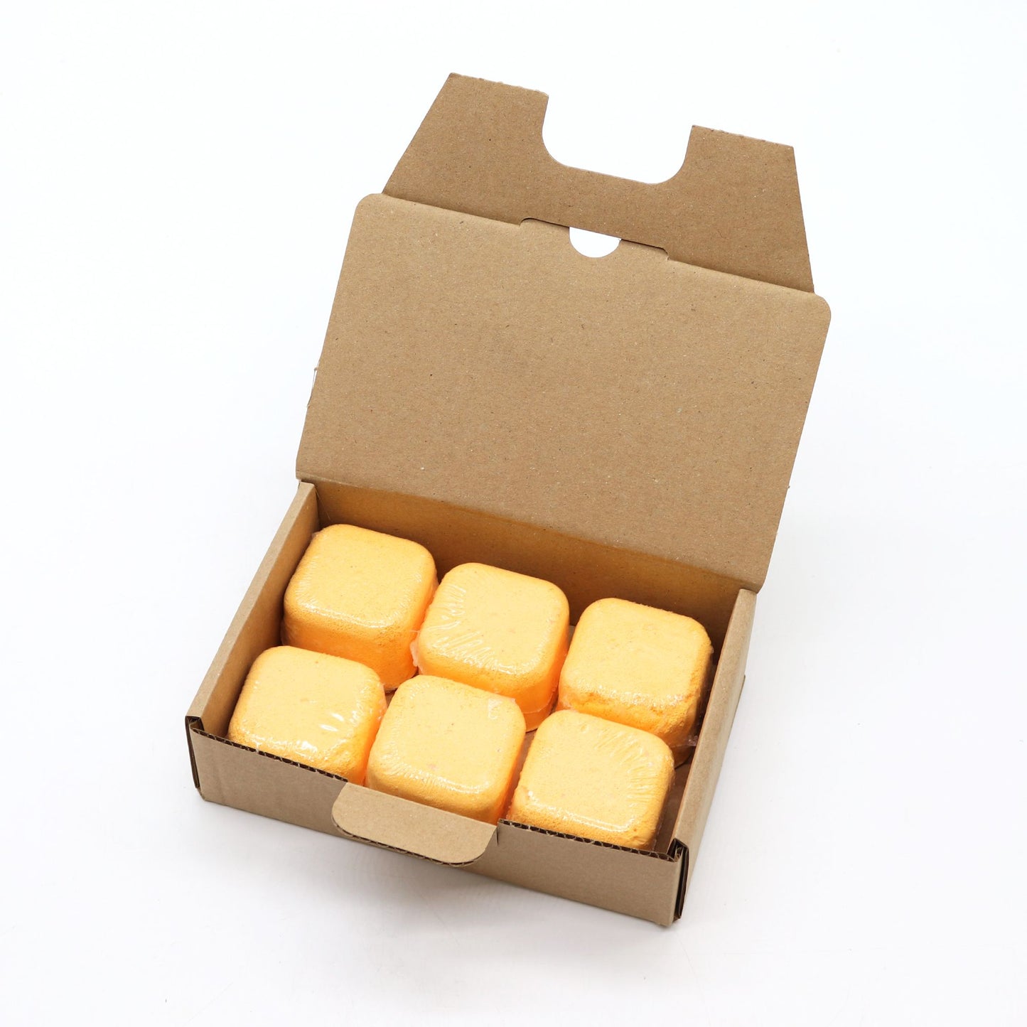 Open cardboard box containing yellow blocks on a white background