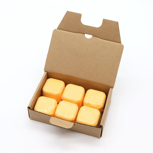 Open cardboard box containing yellow blocks on a white background