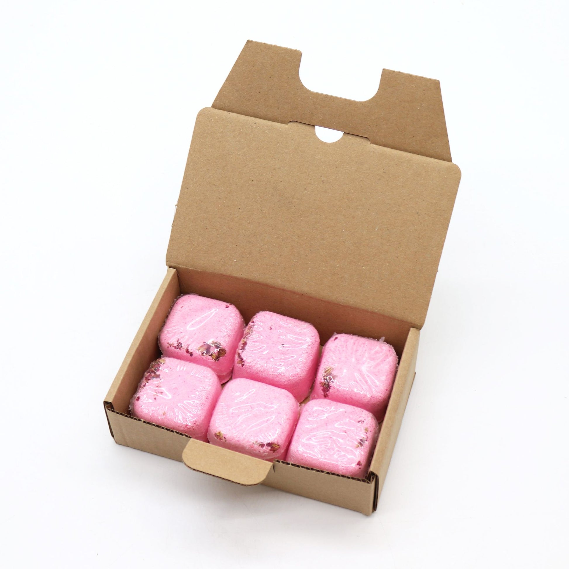 Open cardboard box containing pink marshmallows on a white background