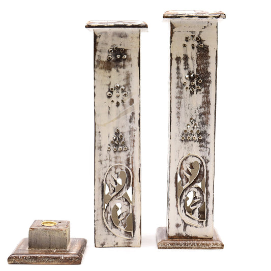 Decorative candle holders with intricate designs on a white background