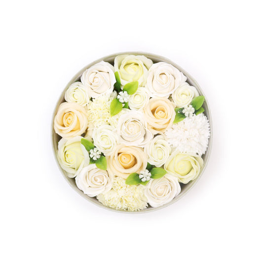 Round arrangement of white and light yellow roses in a box on a white background