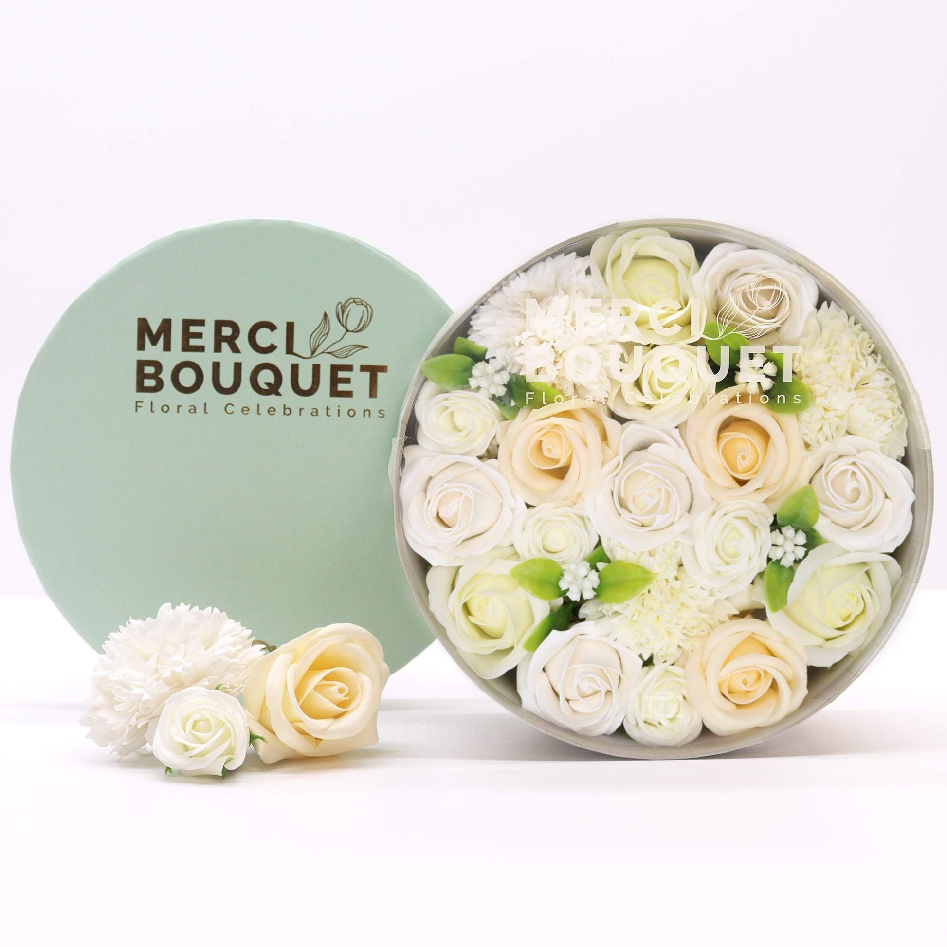 Round box of flowers with 'Merci Bouquet' branding on a white background