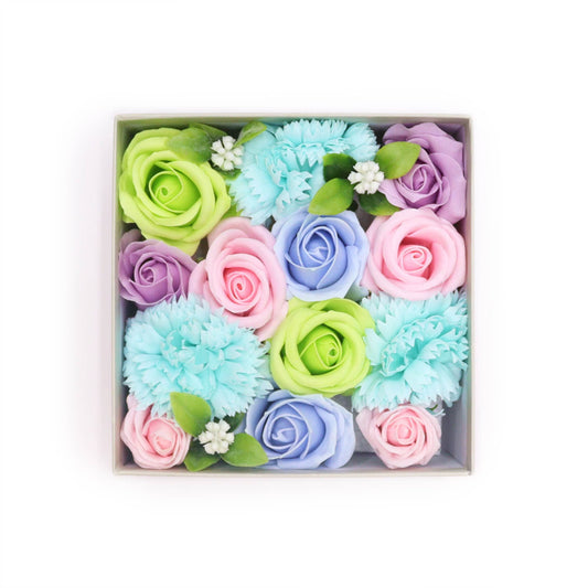 Pastel-colored soap flowers in a box on a white background