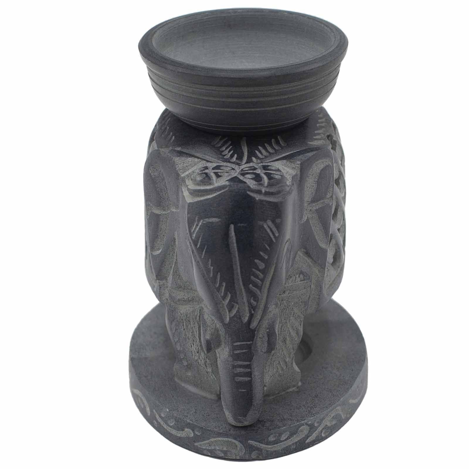 Decorative candle holder with elephant design on a white background