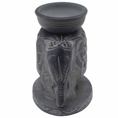 Decorative candle holder with elephant design on a white background