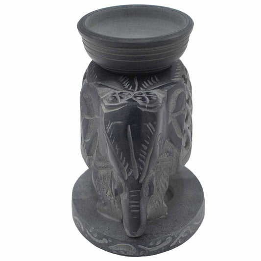 Decorative candle holder with elephant design on a white background
