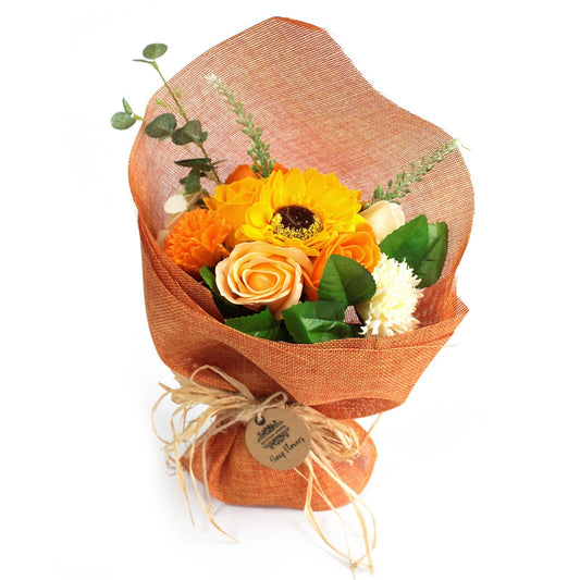 Bouquet of flowers wrapped in orange paper with a tag on a white background