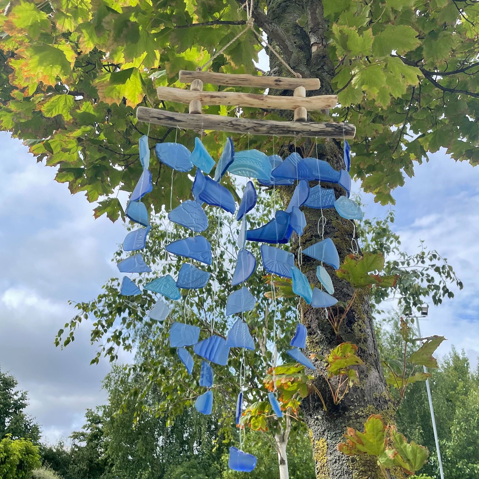 Bring harmony and a touch of nature to your outdoor space with a Recycled Glass Wind Chime Three Stick All Blues. 