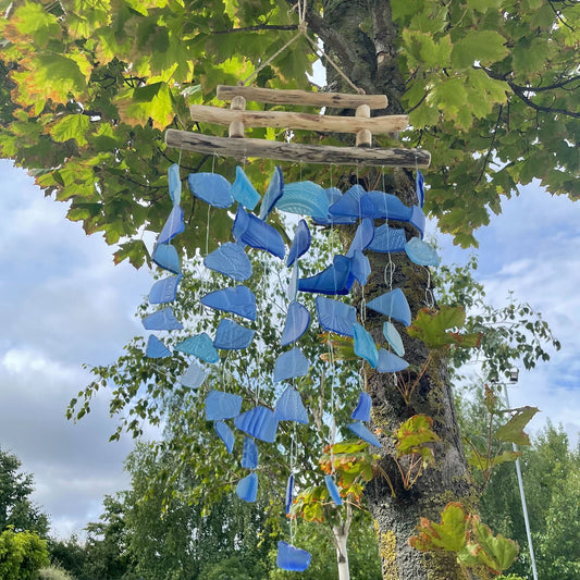 Bring harmony and a touch of nature to your outdoor space with a Recycled Glass Wind Chime Three Stick All Blues. 