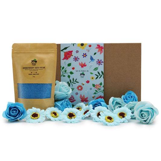 Blue bath bombs and flowers with a branded packaging box on a white background
