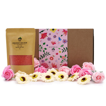 Product set with a brown package, pink floral towel, and decorative flowers on a white background