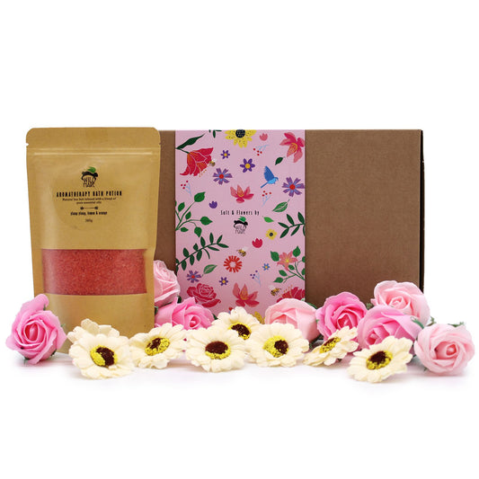Product set with a brown package, pink floral towel, and decorative flowers on a white background