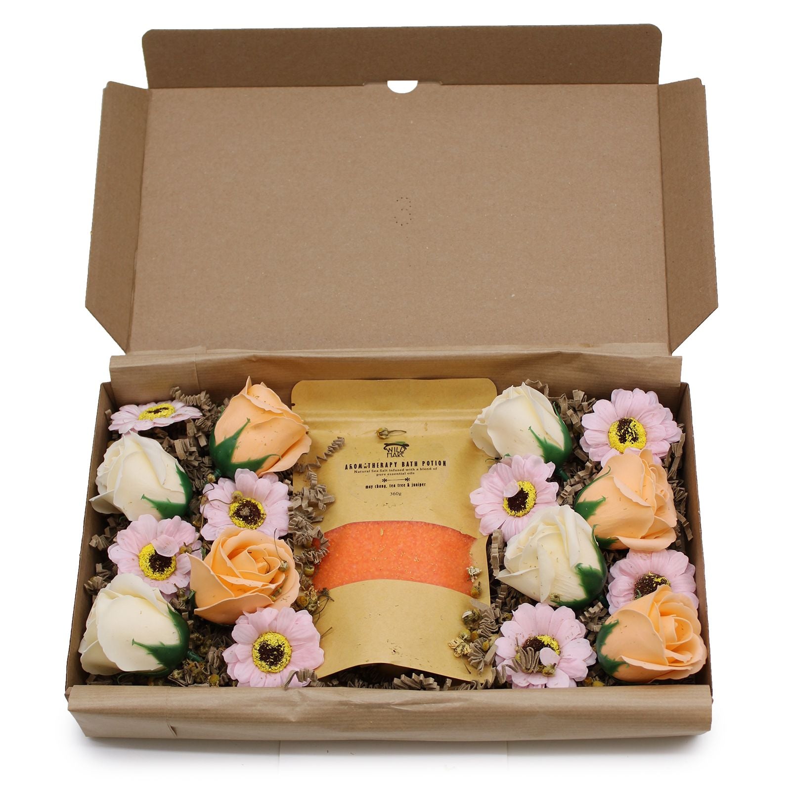 Box of soap flowers with a central bar of soap on a white background