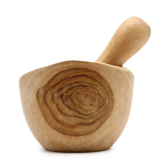 Wooden mortar and pestle on a white background