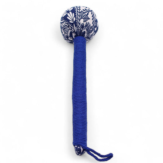 Blue and white patterned dog toy with a long handle on a white background