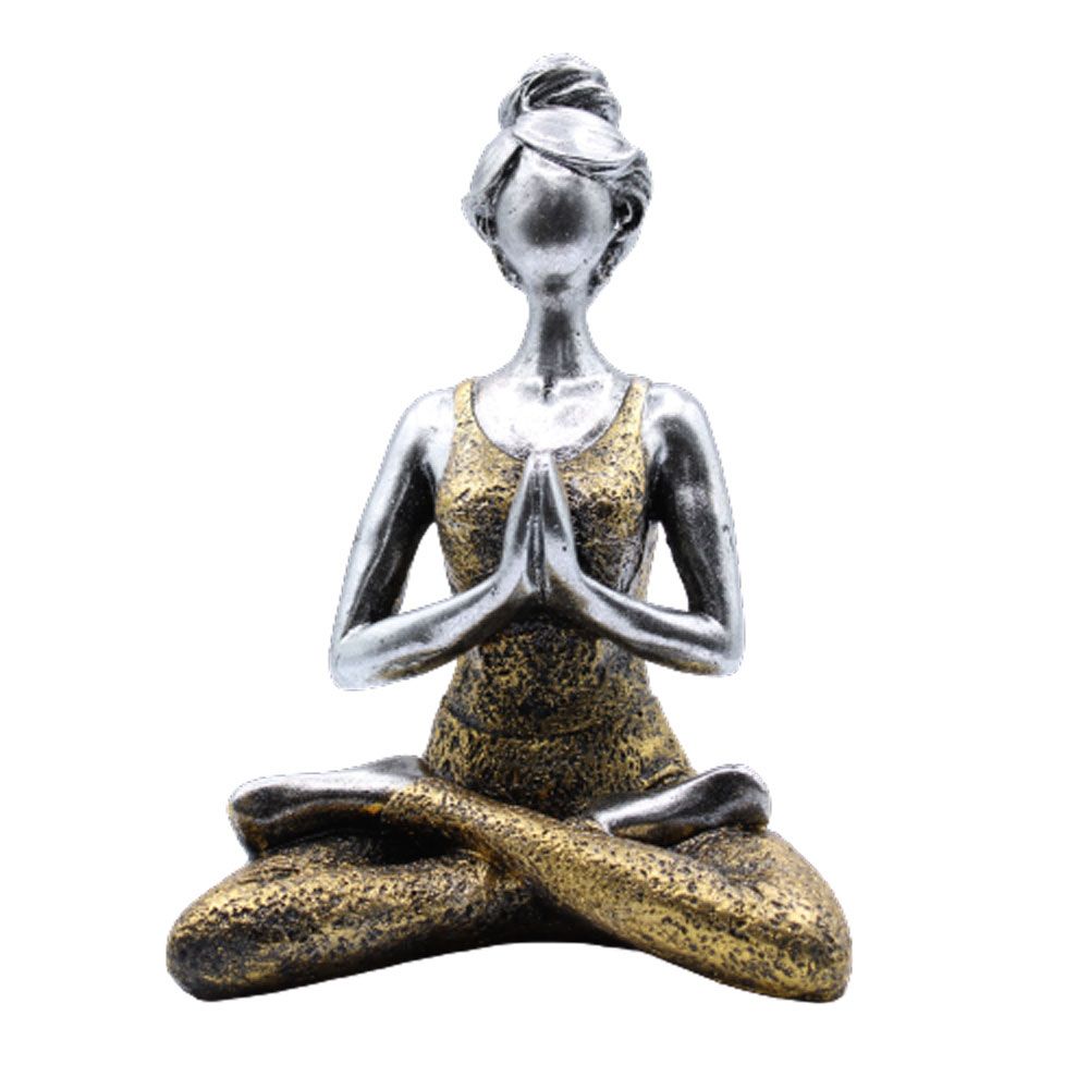Statue of a woman in a yoga pose with a gold and silver finish on a white background