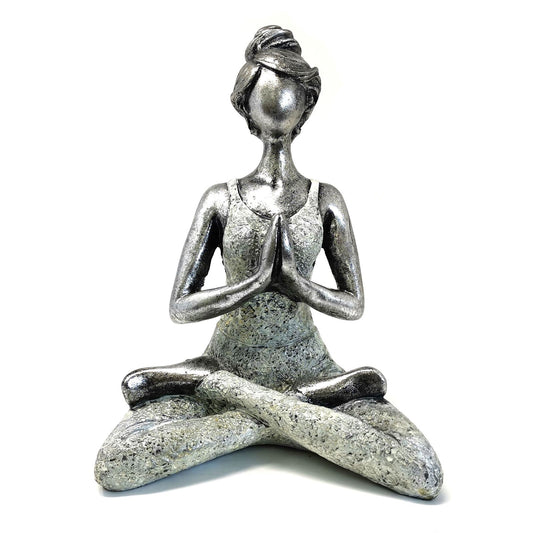 Statue of a meditating figure with a silver top and stone-like base on a white background