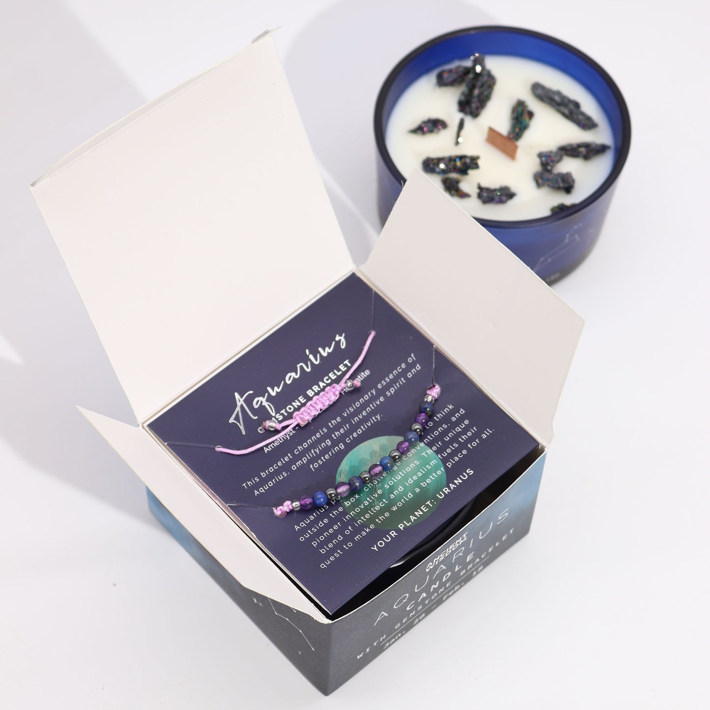 Zodiac Crystal Candle Aquarius with Gemstone Bracelet boxed is beautifully presented in a midnight blue glass jar adorned with silver-embossed star sign constellations.